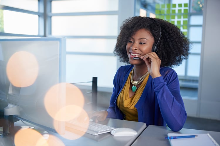 Woman on computer talking in headset to explain how to drive customer engaement Woman on computer talking in headset to explain how to drive customer engaement